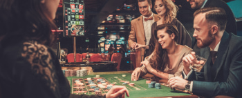 A group of friends gamble at a casino table